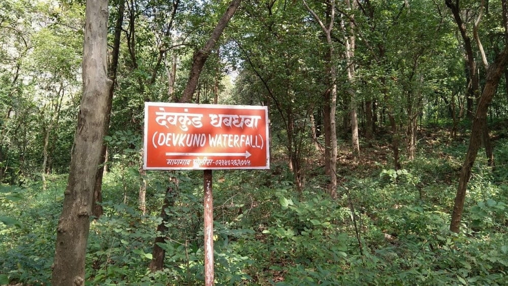 A signboard signalling way to Devkund Waterfall during Trek