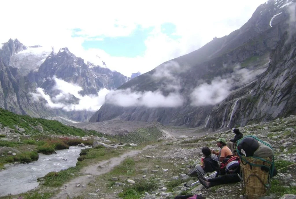 Trekkers Resting & Enjoying the View of Mountains at Satopanth Trek